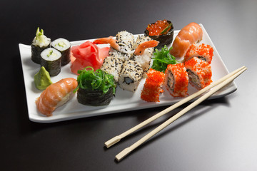 Japanese  seafood  sushi , roll and chopstick on a white plate