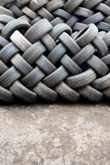 Stacks of car tyres on concrete