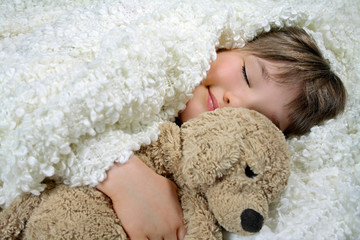 Girl with a white blanket and a soft toy dog