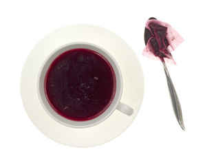 Blueberry tea with teabag and spoon
