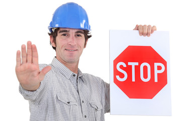Builder holding stop sign