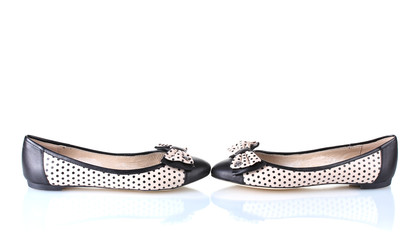 Female flat ballet shoes patterned with black polka dots