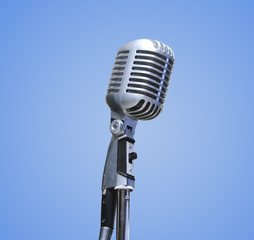 Vintage Microphone over blue background