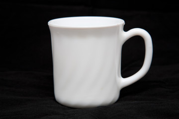 White cup isolated on black background