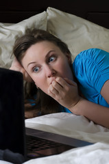 Young woman scared while watching movie