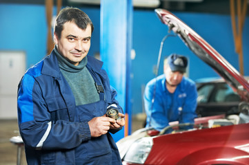 happy mechanic technician at service station