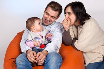 Happy family of parents and daughter in causal clothes