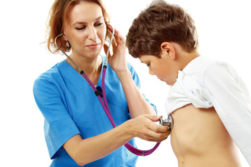 A female doctor is examining boy with a stethoscope