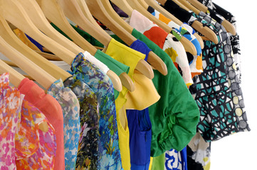 clothes of different colors on wooden hangers.