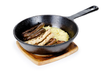 frying pan with a Bavarian sausage on white background