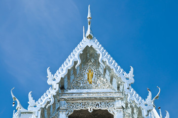 detail of ornately decorated temple roof in bangkok, thailand