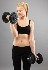 Athletic young lady working out with weights