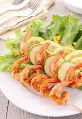 grilled shrimp on stick with salad