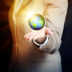 female hand holding earth - business concept