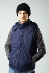 Stylish handsome man in down-padded waistcoat