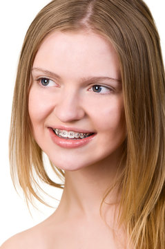 Beautiful young woman with brackets on teeth