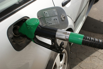 Refueling the car with expensive gasoline