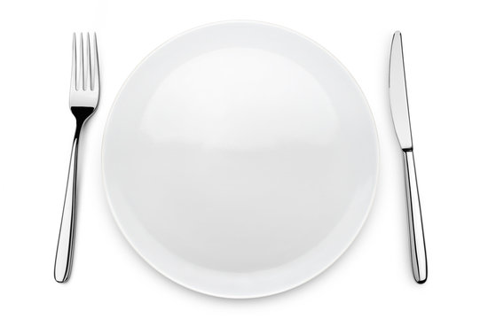 table set with plate, fork and knife on white background