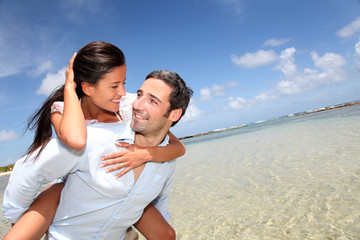 Lovers enjoying sunny day at the beach.