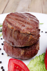 grilled beef fillet medallions with thyme on wood