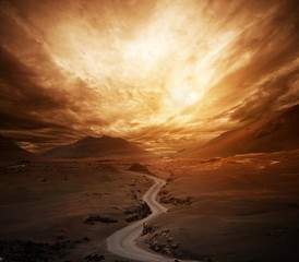 Dramatic sky over road in a valley. - Powered by Adobe