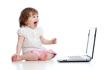 Funny child using a laptop over white background