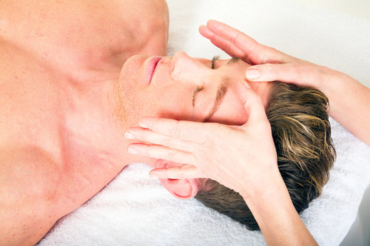 Young Man Receives A Face Massage