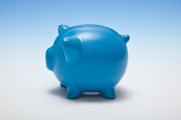 Piggy bank on a graduated blue studio background.