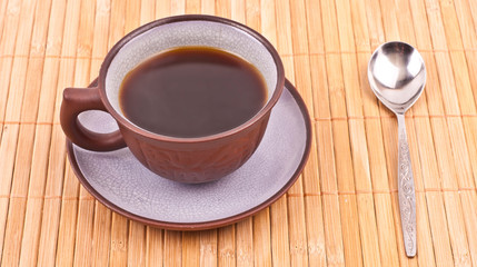 Cup of coffee on the bamboo placemat