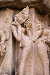 Khajuraho carving of a woman looking in a mirror