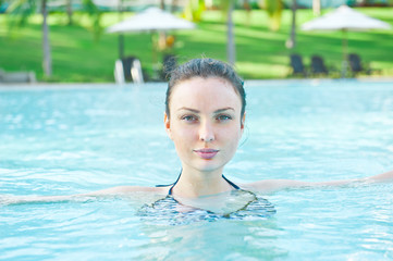 Beautiful woman in the pool at a holiday resort