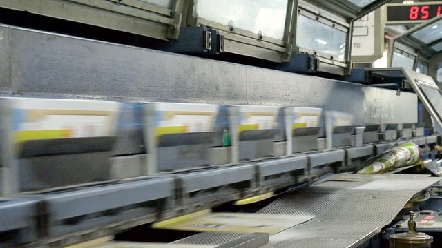 book covers being inserted into a stitching machine