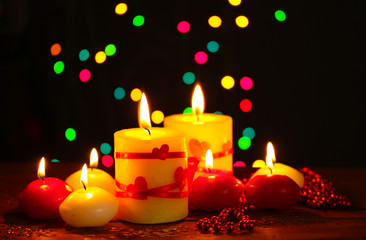 Beautiful candles on wooden table on bright background
