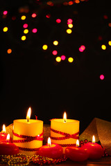 Beautiful candles on wooden table on bright background
