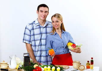 Husband and wife together coooking at home