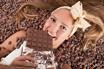beautiful girl with chocolate on cocoa beans