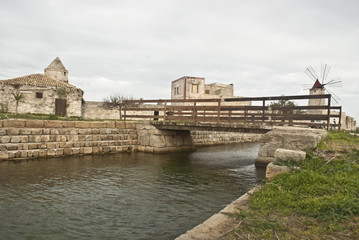 Old windmill with lake and bridge