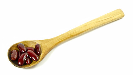 Red kidney beans in a wooden spoon