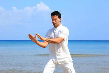 man on the beach meditating