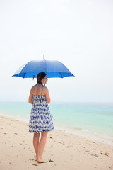 Woman at beach under rain