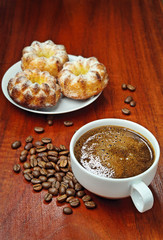 Cup of coffee and three cupcake