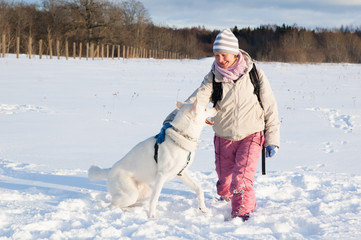 The woman with a dog in winter on walk