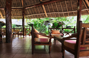 Beautiful resort with chairs, table and exotic trees