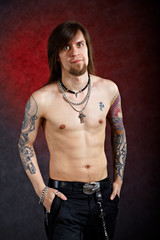 Brutal thoughtful man with tattoo