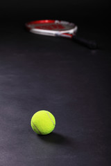tennis racket and balls on black background