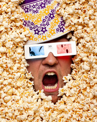 Fototapeta premium Surprised face in popcorn watching 3D movie