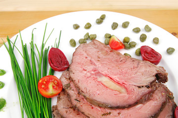 barbecue on white dish over wood