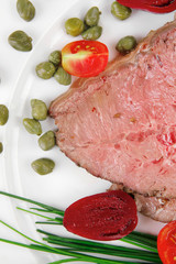 barbecue on white dish over wood