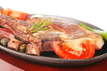 grilled beef meat fillet on metal iron pan
