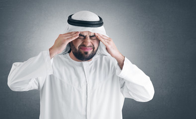 arabian man with a headache - clipping path included